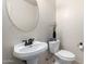 Clean bathroom with pedestal sink and round mirror at 1245 N Compton Cir, Mesa, AZ 85207