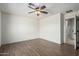Spacious bedroom with wood-look floors and ceiling fan at 1245 N Compton Cir, Mesa, AZ 85207