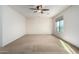 Bright bedroom with ceiling fan and carpet at 1245 N Compton Cir, Mesa, AZ 85207