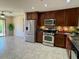 Modern kitchen equipped with stainless steel appliances, granite countertops, and ample cabinet space at 1245 N Compton Cir, Mesa, AZ 85207