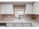 Well-lit kitchen sink area with a window view, providing a cheerful and functional workspace at 228 S 72Nd Pl, Mesa, AZ 85208