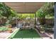 Backyard oasis with a pergola-covered seating area provides a serene escape surrounded by lush greenery and shade at 35202 N 30Th Dr, Phoenix, AZ 85086