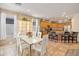 Modern dining area adjacent to an open concept kitchen featuring warm cabinetry and stainless appliances at 35202 N 30Th Dr, Phoenix, AZ 85086