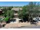 View of home with lush trees, and spacious driveway at 35202 N 30Th Dr, Phoenix, AZ 85086