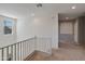 Carpeted upstairs hallway with white railings and ample natural light, leading to various rooms in the home at 35202 N 30Th Dr, Phoenix, AZ 85086