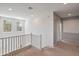Upstairs hallway featuring neutral carpet, white railings, and natural light from the windows creating a welcoming space at 35202 N 30Th Dr, Phoenix, AZ 85086