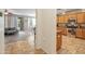 Open-concept kitchen with wood cabinets, stainless steel appliances, and views into the connected dining and living areas at 35202 N 30Th Dr, Phoenix, AZ 85086
