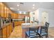 Eat-in kitchen features wood cabinets, granite counters, an island, and stainless steel appliances and fixtures at 35202 N 30Th Dr, Phoenix, AZ 85086