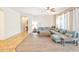 Large living room with light gray sofa, wood coffee table, light-colored walls, and an arched doorway at 35202 N 30Th Dr, Phoenix, AZ 85086