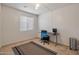 Bright room used as an office features a large window and simple decor with a desk and neutral colors at 35202 N 30Th Dr, Phoenix, AZ 85086