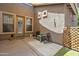 Inviting outdoor patio with seating, artificial turf, and an enclosed privacy screen at 35202 N 30Th Dr, Phoenix, AZ 85086