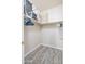 Efficient walk-in closet with gray laminate floors, wire rack shelving, and organizers offers storage options at 35202 N 30Th Dr, Phoenix, AZ 85086