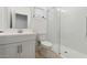 Modern bathroom featuring a white vanity, toilet, and a glass-enclosed shower with subway tile at 4430 N 203Rd Dr, Buckeye, AZ 85396