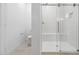 Bathroom featuring a glass shower and a toilet at 4430 N 203Rd Dr, Buckeye, AZ 85396