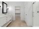 Bright bathroom featuring a walk-in shower, vanity with sink, and walk-in closet at 4430 N 203Rd Dr, Buckeye, AZ 85396