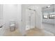 Modern bathroom featuring a glass shower and a toilet at 4430 N 203Rd Dr, Buckeye, AZ 85396