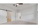 Spacious bedroom featuring sliding barn doors and a view into adjacent rooms, offering a modern, open feel at 4430 N 203Rd Dr, Buckeye, AZ 85396