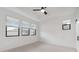 Bright bedroom featuring multiple windows and a ceiling fan, providing ample light and comfort at 4430 N 203Rd Dr, Buckeye, AZ 85396