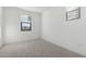 Cozy bedroom featuring neutral carpet, white walls, and a bright window, creating a serene atmosphere at 4430 N 203Rd Dr, Buckeye, AZ 85396