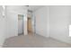 Clean, carpeted bedroom with an open closet and doorway providing a bright and airy atmosphere at 4430 N 203Rd Dr, Buckeye, AZ 85396