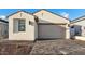 Single Gathering home featuring a neutral color palette, a two-car garage, and a nicely paved driveway at 4430 N 203Rd Dr, Buckeye, AZ 85396