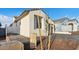 Home exterior showcasing its neutral tones, landscape, and paved driveway under a blue sky at 4430 N 203Rd Dr, Buckeye, AZ 85396