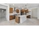 Modern kitchen with wooden cabinets, stainless steel appliances, island, and open layout for entertaining at 4430 N 203Rd Dr, Buckeye, AZ 85396