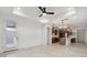 Open-concept living area with kitchen view, recessed lights, ceiling fan, and access to the backyard at 4430 N 203Rd Dr, Buckeye, AZ 85396