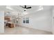Spacious living room with kitchen view, fan, recessed lighting, and tile floors at 4430 N 203Rd Dr, Buckeye, AZ 85396
