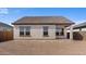 View of the home's rear exterior showing a covered patio and an empty backyard at 16625 N Lunar St, Maricopa, AZ 85138
