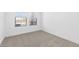 Bedroom with neutral carpet and two windows at 16625 N Lunar St, Maricopa, AZ 85138
