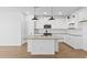 Modern kitchen featuring a large island, stainless appliances, and wooden floors at 16625 N Lunar St, Maricopa, AZ 85138