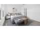 Stylishly decorated main bedroom with a gray bed, bench, and carpet at 16625 N Lunar St, Maricopa, AZ 85138