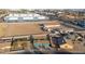 Aerial view of home with pool surrounded by commercial buildings and desert landscape at 323 N 69Th Ave, Phoenix, AZ 85043