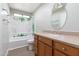 Bathroom with shower, tropical-themed shower curtain and wood vanity at 323 N 69Th Ave, Phoenix, AZ 85043
