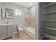 Bathroom featuring a shower and tub combination, vanity, and storage shelves at 323 N 69Th Ave, Phoenix, AZ 85043