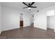 Spacious bedroom boasting neutral walls, herringbone floors, and access to a bathroom at 323 N 69Th Ave, Phoenix, AZ 85043