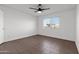Bright bedroom featuring herringbone pattern floor, a ceiling fan, and a large window at 323 N 69Th Ave, Phoenix, AZ 85043