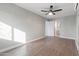 Bedroom featuring a ceiling fan, wood floors and an open doorway to the bathroom at 323 N 69Th Ave, Phoenix, AZ 85043