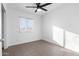 A bright bedroom has large windows and tiled floors adding modern appeal at 323 N 69Th Ave, Phoenix, AZ 85043