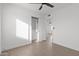 Clean bedroom with modern ceiling fan, closet, and opening to hallway at 323 N 69Th Ave, Phoenix, AZ 85043