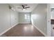 A spacious bedroom with wood floors, a ceiling fan and natural light at 323 N 69Th Ave, Phoenix, AZ 85043