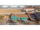 Single-story house featuring an aqua exterior, brown roof, and mature trees at 323 N 69Th Ave, Phoenix, AZ 85043