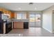 Well-lit kitchen with granite countertops, stainless steel appliances, and light wood cabinetry at 323 N 69Th Ave, Phoenix, AZ 85043