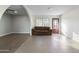 Inviting living room showcases neutral paint, tiled floor, and arched doorways at 323 N 69Th Ave, Phoenix, AZ 85043