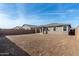 View of backyard with covered patio, block wall, and spacious, landscaped yard at 5335 W Manzanita Dr, Glendale, AZ 85302