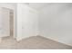A carpeted bedroom with a closet, featuring fresh neutral paint, trim, and carpet at 5335 W Manzanita Dr, Glendale, AZ 85302