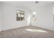 A carpeted bedroom with natural light and neutral paint, trim, and carpet at 5335 W Manzanita Dr, Glendale, AZ 85302