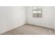 A cozy bedroom with neutral carpet and natural light from a large window at 5335 W Manzanita Dr, Glendale, AZ 85302