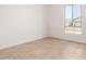 Bright bedroom with a window offering natural light and neutral flooring at 5335 W Manzanita Dr, Glendale, AZ 85302